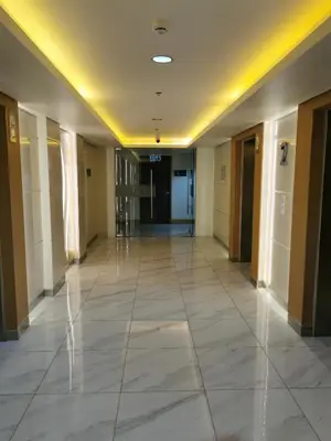 an empty hallway in a building with ailed floor at Shore 3 tower 2 mall of Asia in Manila