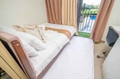 a bed in a room with a window at 3 Condos*8 Beds*3 bathrooms*3 Kitchens*4 Pools*@ Shore2 MOA in Manila