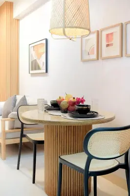a table with a bowl of fruit on it in a living room at Shore 3 Mall of Asia - Sofian Suites in Manila
