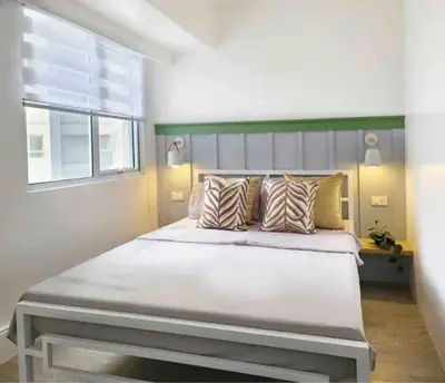 a large bed in a bedroom with a window at BGC - Two Bedroom Condo with Game Room with 400mbps WiFi- 09 in Manila