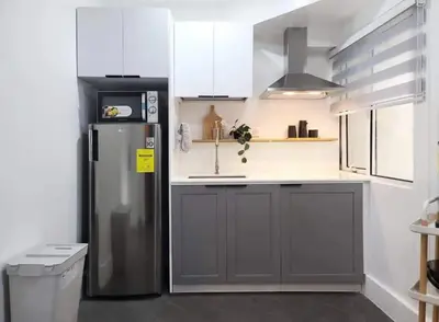a kitchen with a refrigerator and a sink at BGC - Two Bedroom Condo with Game Room with 400mbps WiFi- 09 in Manila