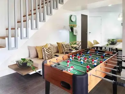 a living room with a foosball table at BGC - Two Bedroom Condo with Game Room with 400mbps WiFi- 09 in Manila