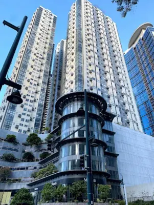 two tall buildings in a city with a building at BGC - Two Bedroom Condo with Game Room with 400mbps WiFi- 09 in Manila