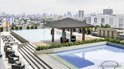 a swimming pool on the roof of a building at Elane's Staycation -Mezza 2 1 br in Manila