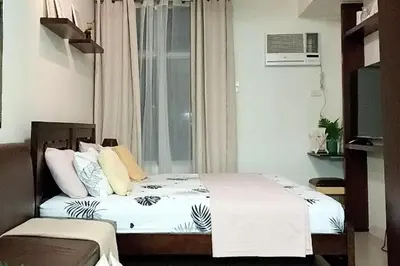 a bedroom with two beds and a window at Fully-furnished Condo Accommodation in Makati in Manila