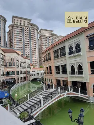 a city with tall buildings and a green river at Condo in McKinley Hill near Grand Canal Mall (Balai Bellini) in Manila