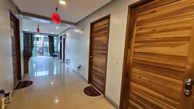 a hallway with a wooden door in a house at Backpackers Transient Room in Manila