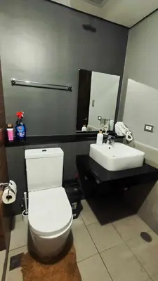 a bathroom with a white toilet and a sink at Bayfront Suite in Pasay Near NAIA Terminal, PICC, Star City, MOA and US Embassy - Pet-Friendly, Wi-Fi & Netflix, Free Swimming Pool, Sauna and Gym, Work from Home Ready in Manila