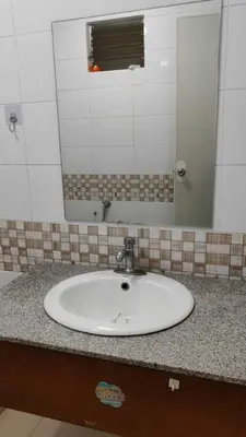 a white sink in a bathroom with a mirror at V hotel paranaque in Manila