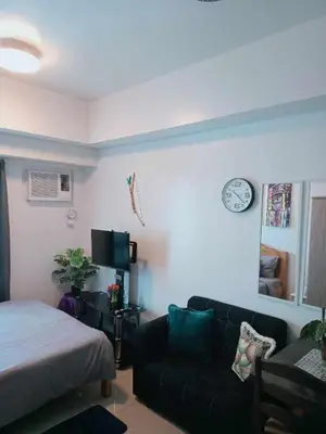 a living room with a bed and a couch at Sweet Kathleen at The Beacon Makati in Manila