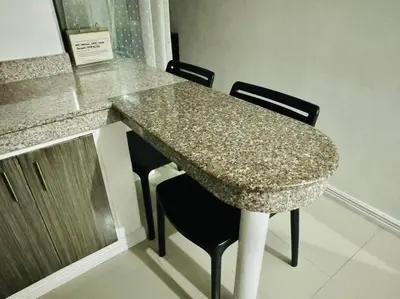 a table with two chairs and a granite counter top at Birch Tower a1 front of RobinsonMla Rizal Park in Manila