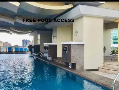 a swimming pool with a water slide in a building at Birch Tower a1 front of RobinsonMla Rizal Park in Manila