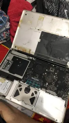 a broken laptop computer sitting on top of a table at 1BR Condo Unit W/ Fantastic View near US Embassy in Manila