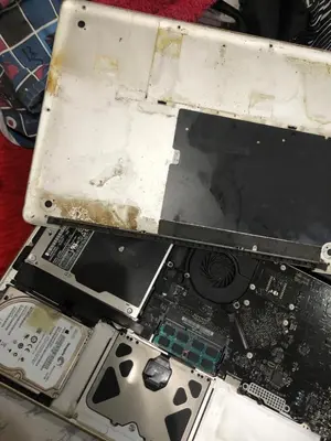 a broken laptop computer sitting on top of a table at 1BR Condo Unit W/ Fantastic View near US Embassy in Manila
