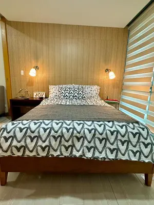 a bedroom with a large bed in a room at 1 BR Uptown BGC Cozy Condo Netflix 200Mb Wi-Fi in Manila