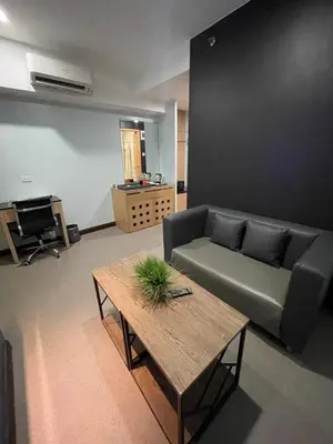a living room with a couch and a table at Homes at Bay Area Suites by SMS Hospitality in Manila