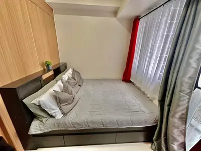a small bed in a room with a window at Apartment Seaside Bliss in Manila