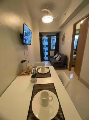 a living room with a table with two cups on it at Mall of Asia Shore 3 near Airport Pasay Manila 1 Bedroom Wifi in Manila