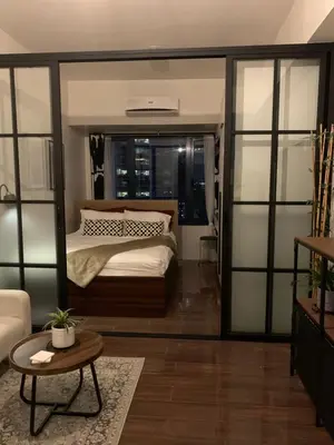 a bedroom with a bed and a table in a room at TOP RATED 2026 Traveler Award Air Residences Manila Makati City Comfort and Style Budget Friendly Top rated prime location very short ride to and from airport in Manila