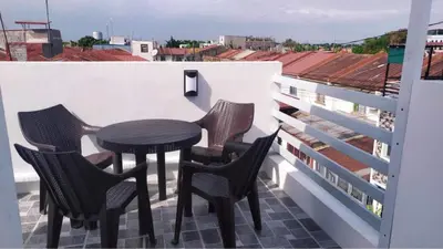 a table and chairs on a balcony with a view at Saphir Townhouse 5 to 6 pax rooftop terrace, Cavite in Imus