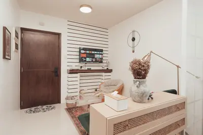 a room with a table with a vase on it at Modern Luxe Condo Unit in Cavite in Imus