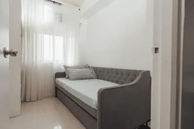 a bed in a room with a window at Modern Luxe Condo Unit in Cavite in Imus