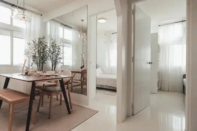a dining room with a table and a bedroom at Modern Luxe Condo Unit in Cavite in Imus