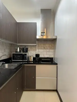 a kitchen with a sink and a microwave at Gramercy Residences 46th Floor 1 Bedroom Sunset View in Manila