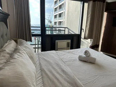 a bedroom with a bed with a towel on it at Gramercy Residences 46th Floor 1 Bedroom Sunset View in Manila