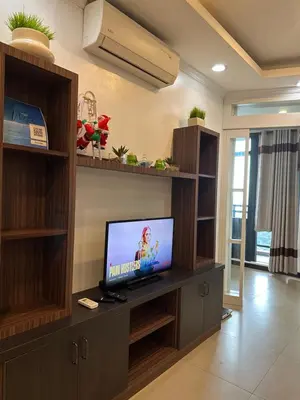 a living room with a tv on a shelf at Gramercy Residences 46th Floor 1 Bedroom Sunset View in Manila
