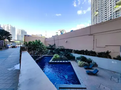 a swimming pool on the side of a building at 1BR Condotel Suite at Sunshine100 City Plaza #SS01 in Manila