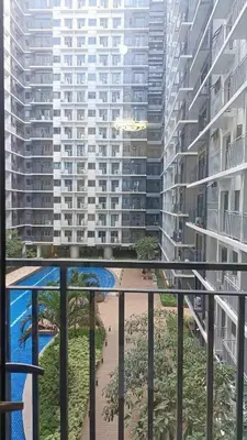 a balcony with a view of a large building at JN Staycation at Shore 3 Mall of Asia in Manila