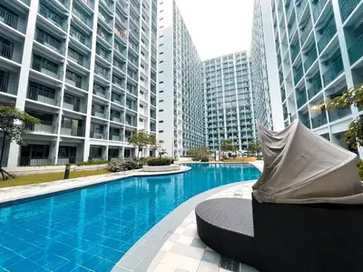 a swimming pool in a city with tall buildings at Mid-Century Extent Condo Unit @ Shore 2, MOA in Manila