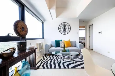 a living room with a zebra print rug at Executive Suite - BSA Twin Towers, Ortigas Ctr in Manila