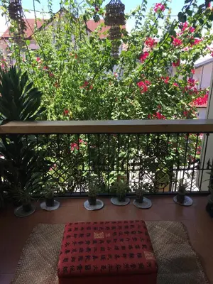 a balcony with pink flowers and plants on a fence at Guesthouse Cavite in Dasmariñas