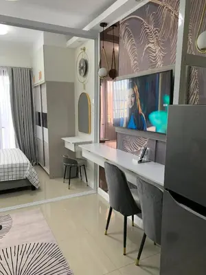 a living room with a desk and a bedroom at POSH 1 BR Unit+ Netflix*WIFI @ Shore 2 in Manila