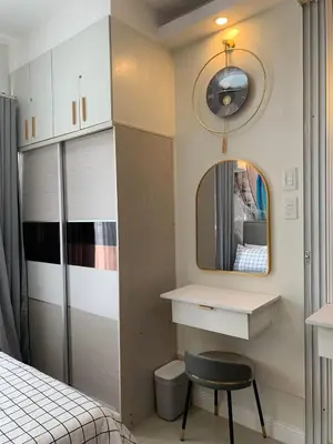 a bedroom with a vanity and a mirror and a chair at POSH 1 BR Unit+ Netflix*WIFI @ Shore 2 in Manila