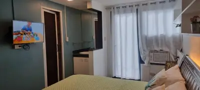 a bedroom with a bed and a tv on the wall at ADB AVENUE TOWER in Manila