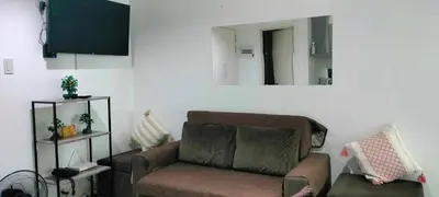 a living room with a couch and a mirror at Staycation at Azure Urban Resorts in Manila