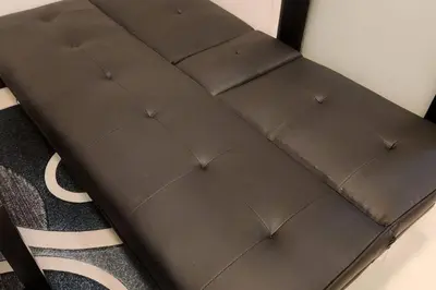 a brown bed sitting on top of a carpet at Great View in Makati in Manila
