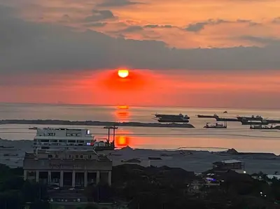 a sunset over a body of water with planes at Coast of Finland: Stunning Manila Bay & Sunset in Manila