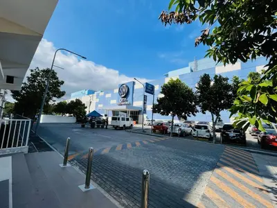 a parking lot with cars parked in front of a building at Amiela’s Place in Trece Martires