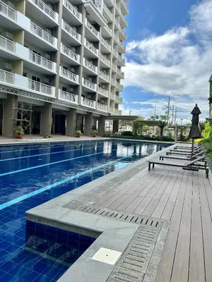 a large apartment building with a swimming pool at The Atherton in Manila