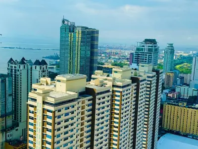 an aerial view of a city with tall buildings at Birch Tower a2 Front of Robinson Mall in Manila