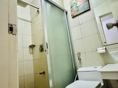 a bathroom with a shower and a toilet and a sink at Birch Tower a2 Front of Robinson Mall in Manila