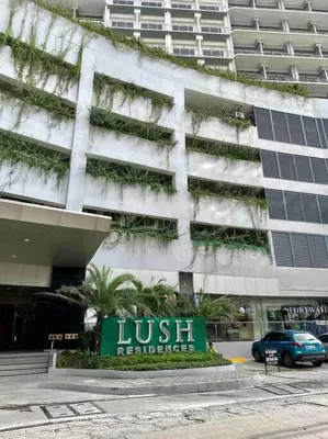 a hotel with a sign in front of a building at Makati Staycation by Marco - SMDC Lush in Manila