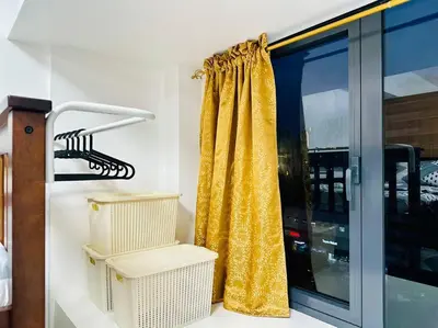 a yellow curtain next to a window in a room at Makati Staycation by Marco - SMDC Lush in Manila