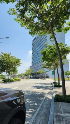 a car parked on a street with a tall building at Le Palis Suite in Bukal