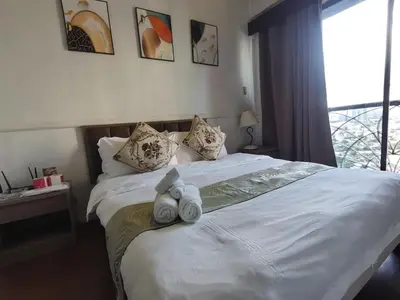 a bedroom with a bed with two teddy bears on it at citadel inn apartment in Manila