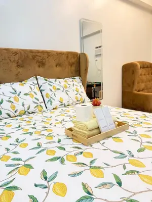 a bed with a blanket with a tray of towels at Starlight Suites in Trece Martires